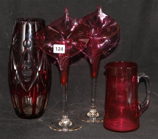 A pair of cranberry Jack in the Pulpit vases, a cranberry jug and an overlaid vase